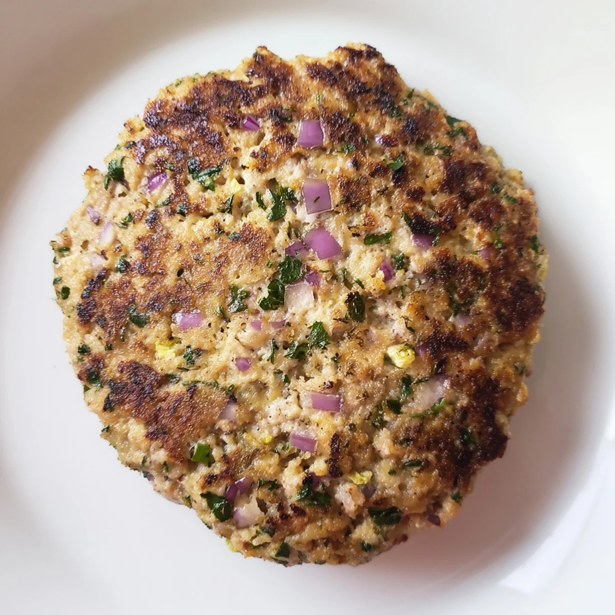 Savory turkey brunch burger patties plated beside poached eggs, ready for a hearty American brunch.