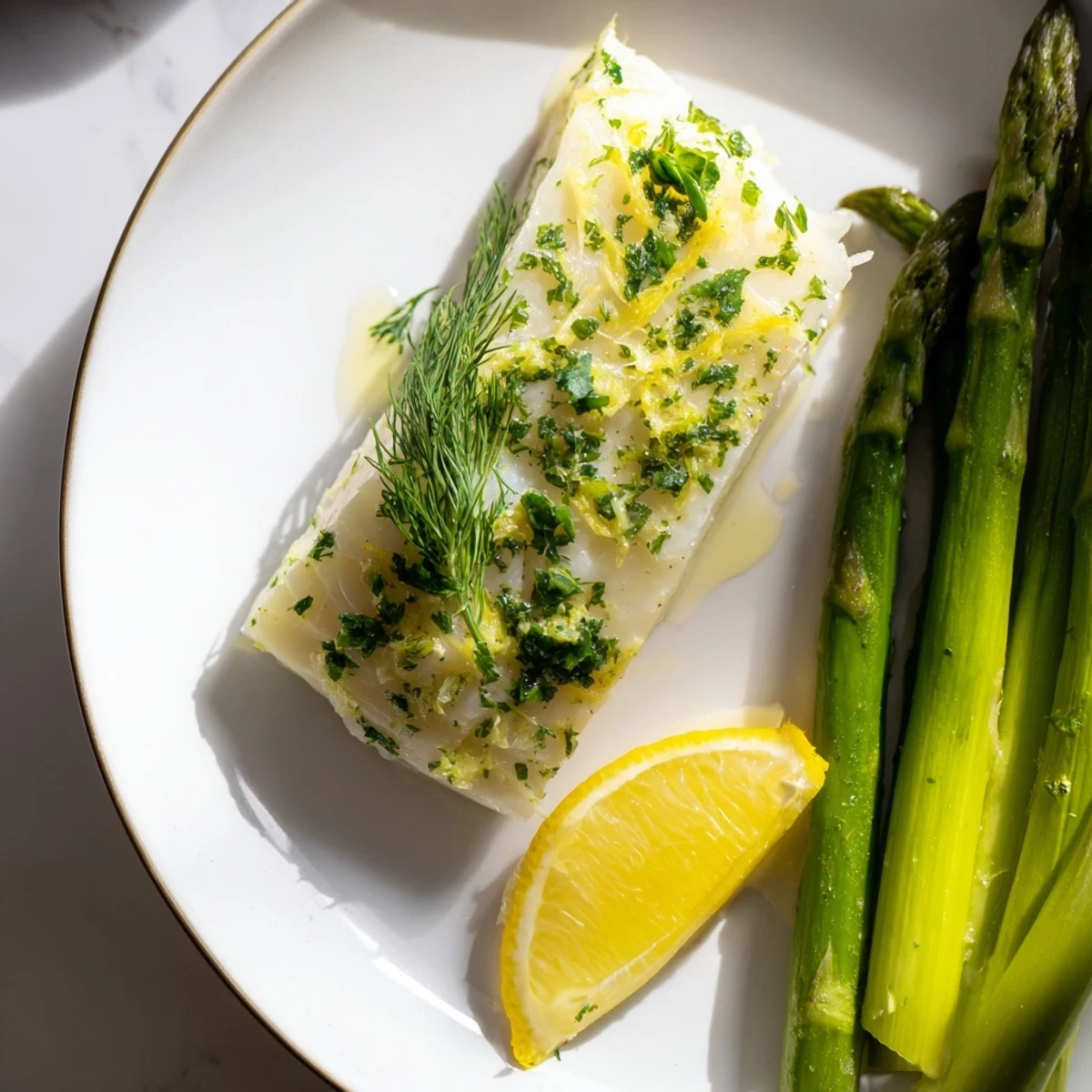 A vibrant sheet pan lemon herb cod and asparagus meal, garnished with fresh parsley and lemon slices.