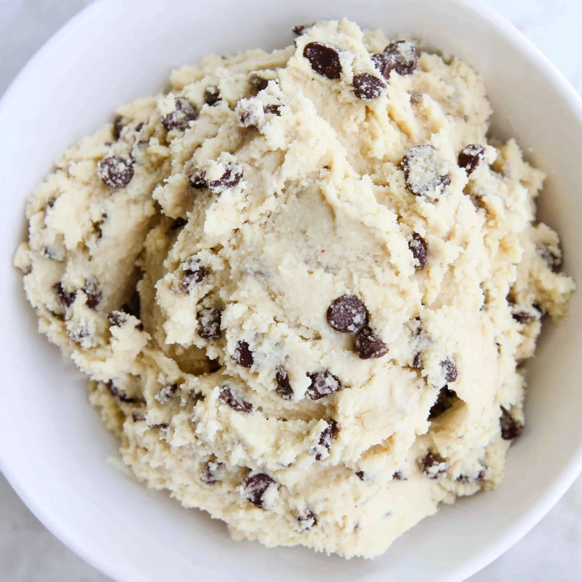 Enjoy a scoop of Edible Keto Cookie Dough with a spoon ready for a low carb dessert treat.  