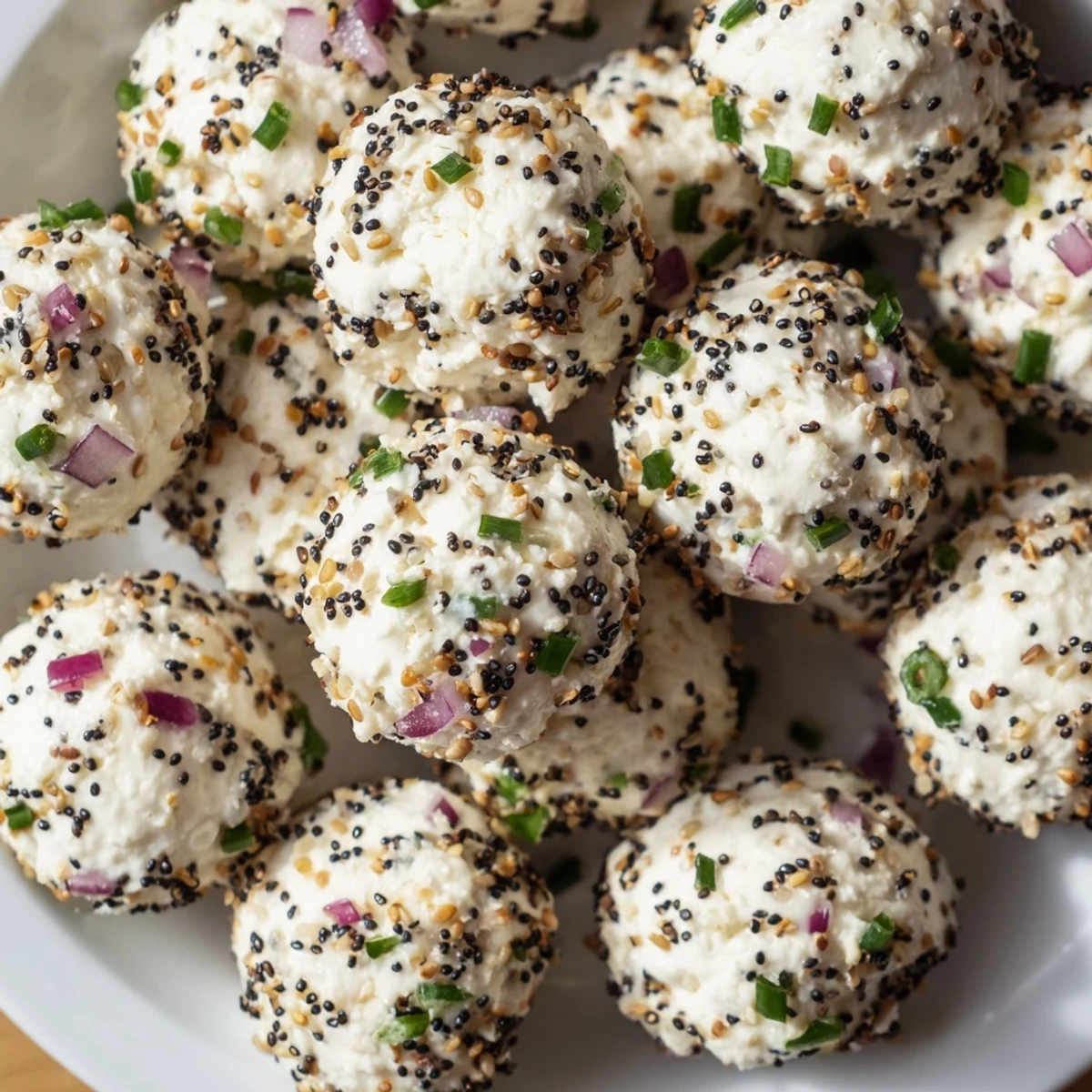 Everything Bagel Cottage Cheese Bites served with sliced cucumber and red bell pepper on the side.