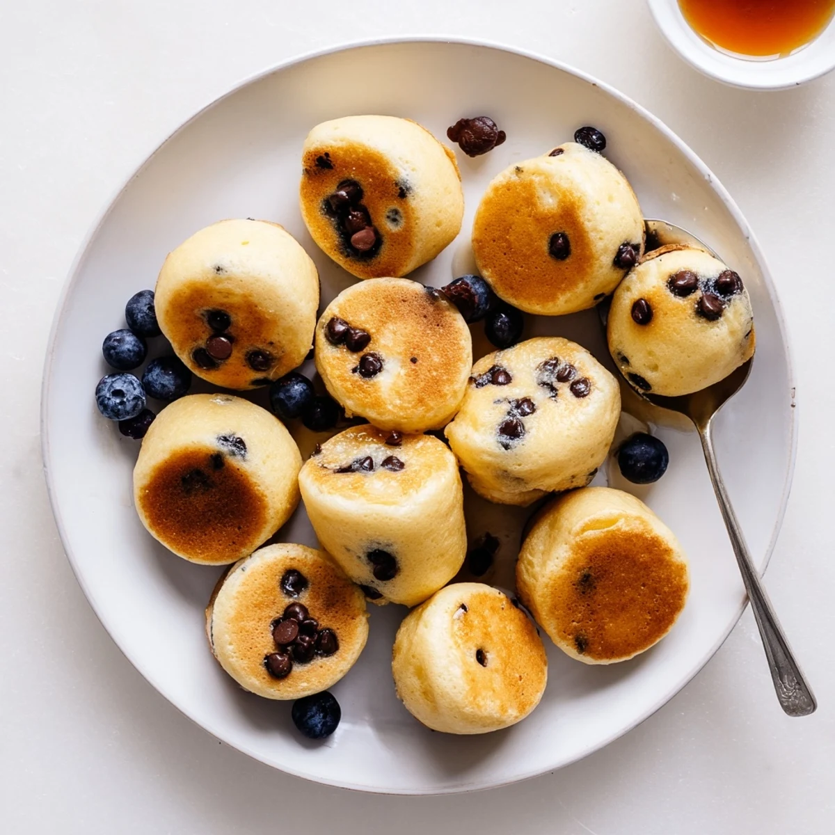 Fluffy Pancake Poppers fresh from the oven, golden brown and perfect for dipping in syrup.