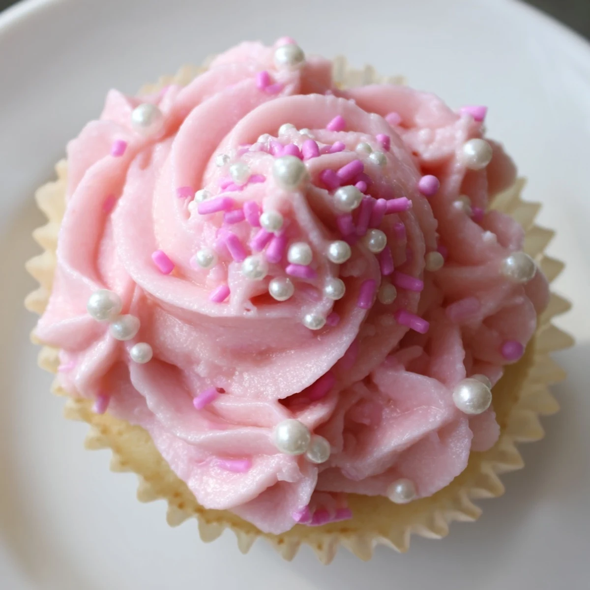 Brightly frosted Girl Baby Shower Cupcakes with creamy pink buttercream, displayed on a white platter ready for a joyful party.