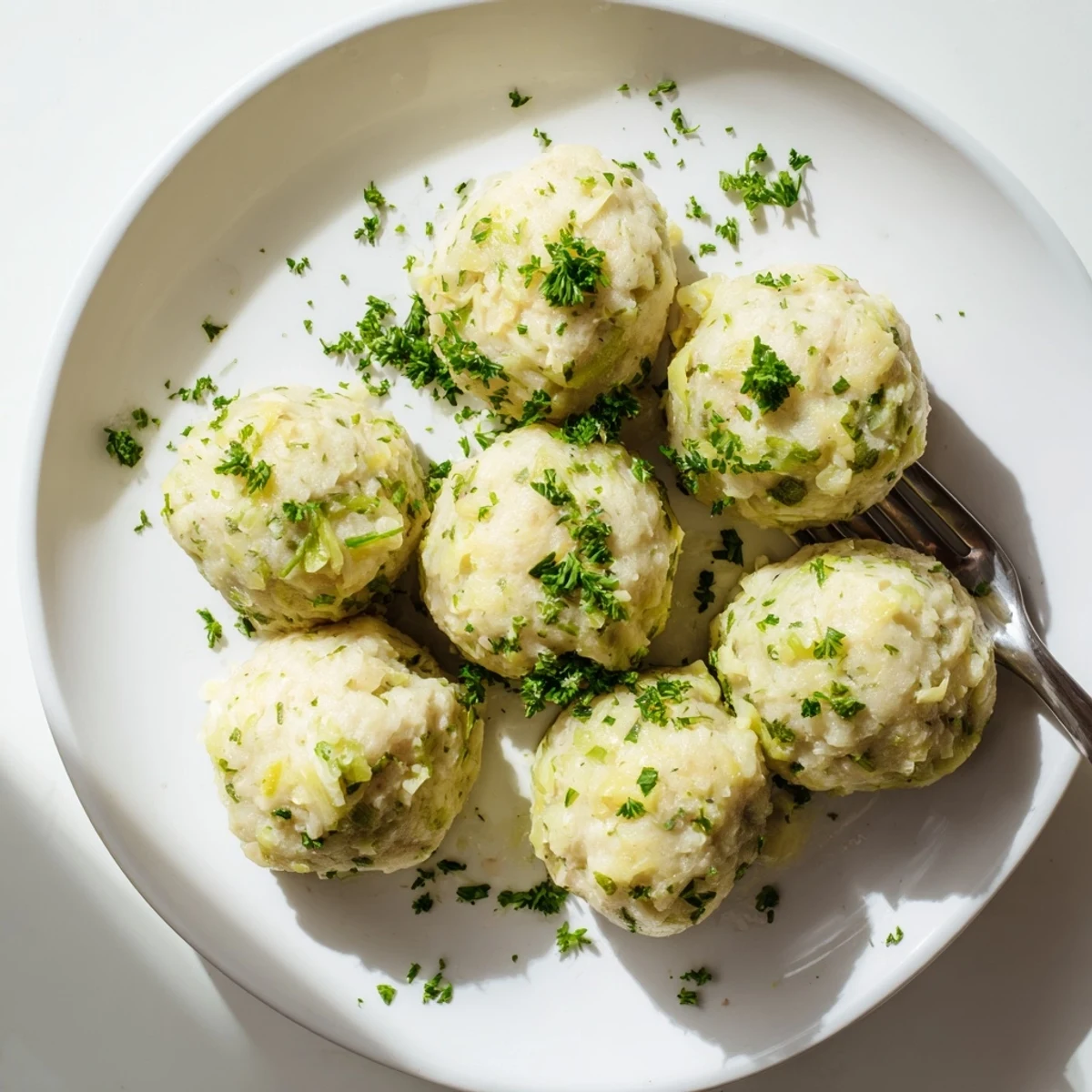 Golden German Cabbage Dumplings served on a plate, ready to be enjoyed as a comforting main dish.