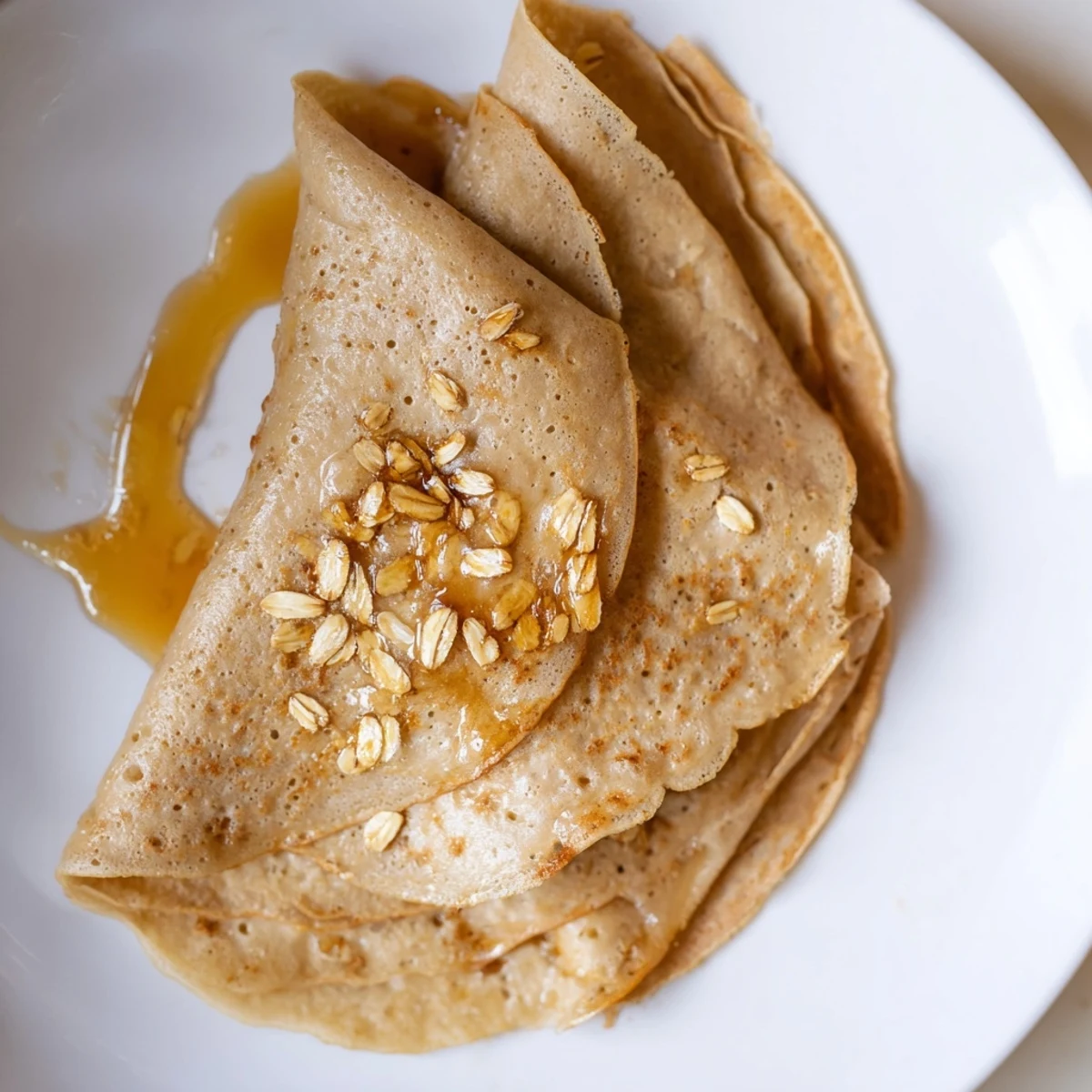 Breakfast plate featuring healthy oatmeal crepes filled with yogurt and sliced banana