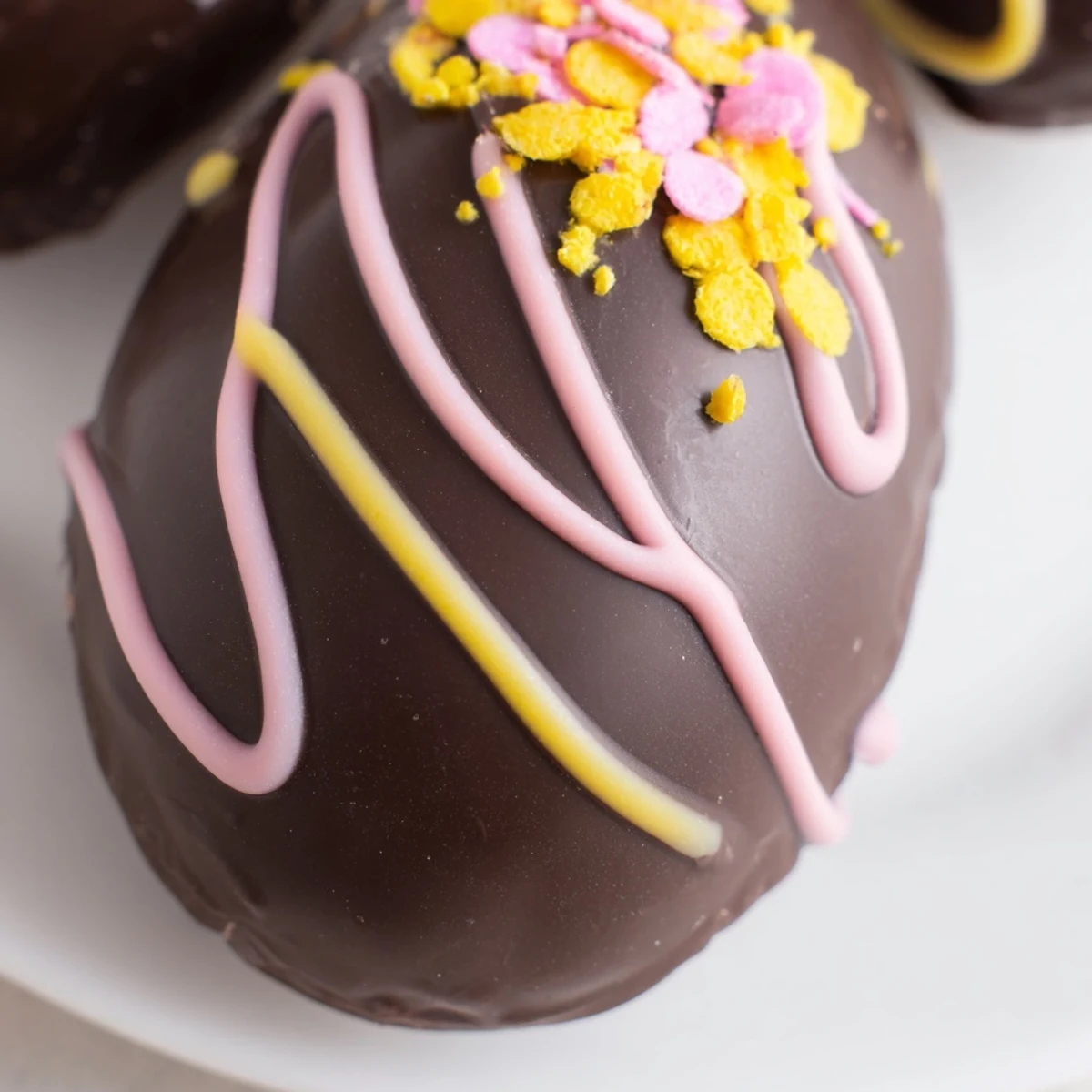 Chocolate coated Cool Whip Easter Eggs displayed on festive Easter serving platter