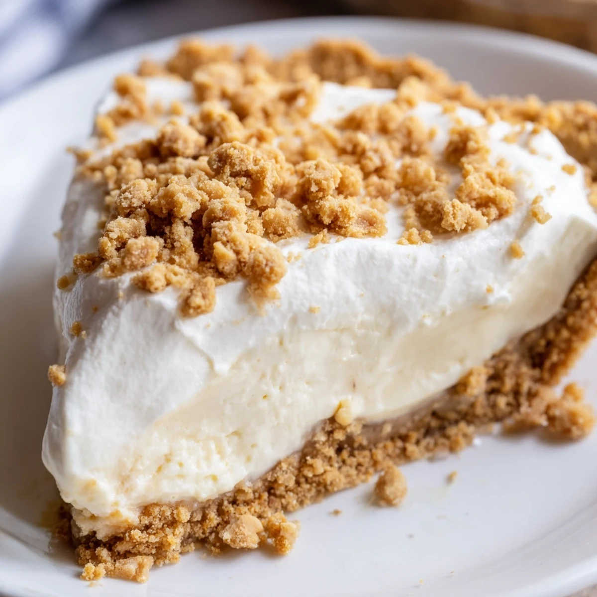 Creamy Amish Peanut Butter Dream Pie topped with whipped cream and golden peanut butter crumbles