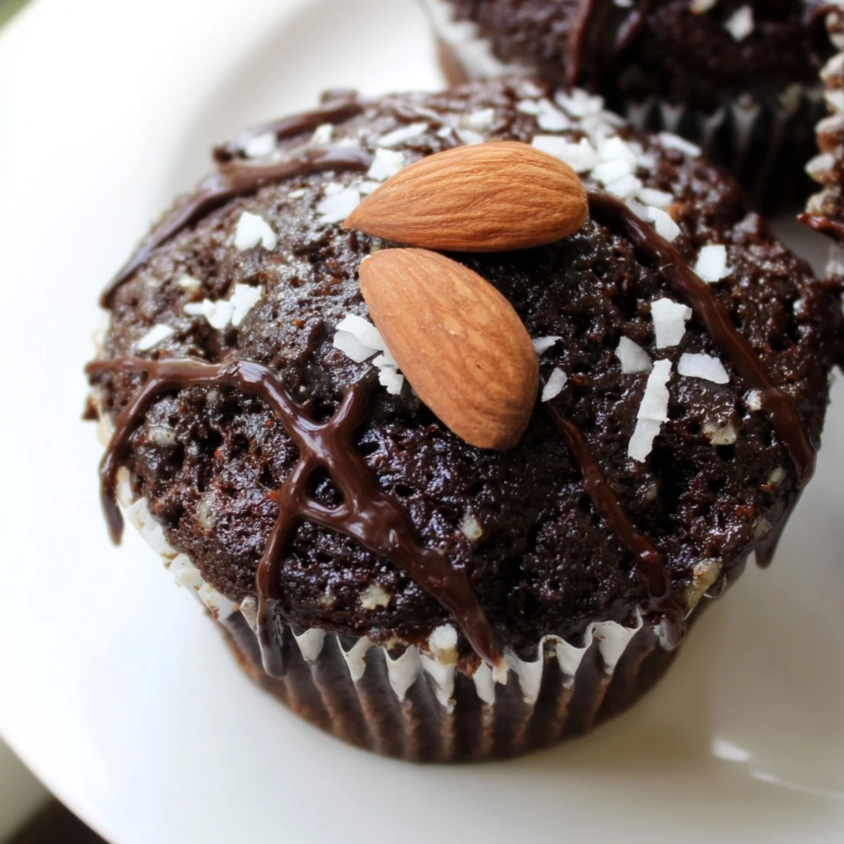 Fudgy gluten-free Flourless Almond Joy Cupcakes served on a white plate for dessert