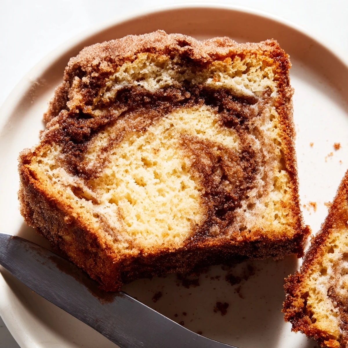 Warm snickerdoodle banana bread loaf topped with crackly cinnamon sugar fresh from the oven