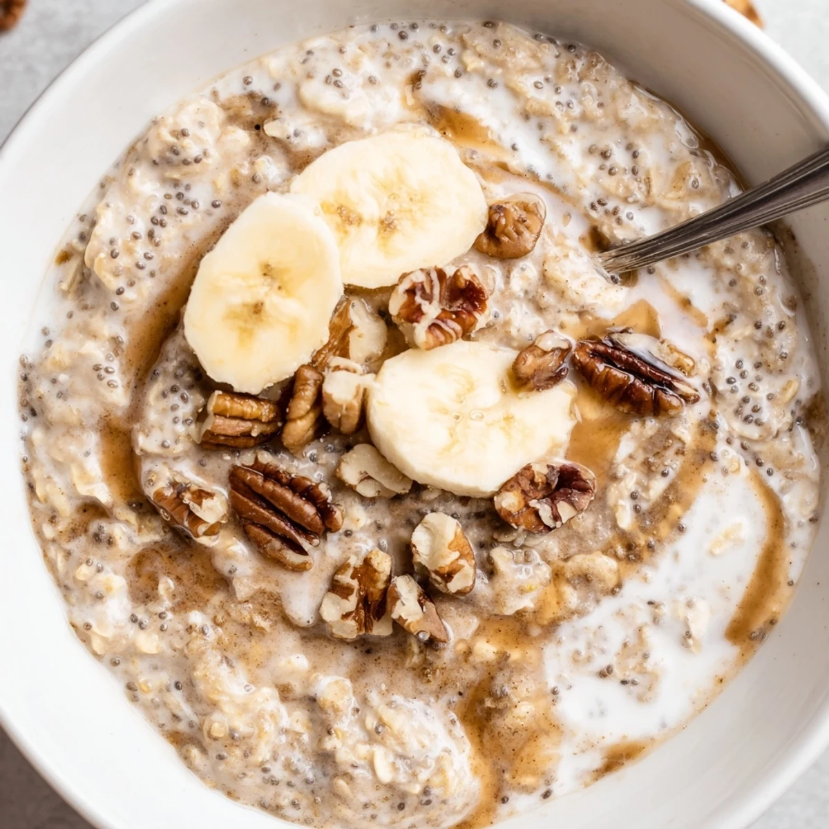 Creamy Brown Sugar Coffee Overnight Oats topped with sliced banana and toasted pecans