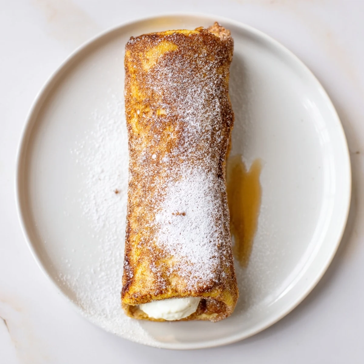 Cinnamon Roll French Toast Roll Ups steaming, golden, brushed with cinnamon sugar