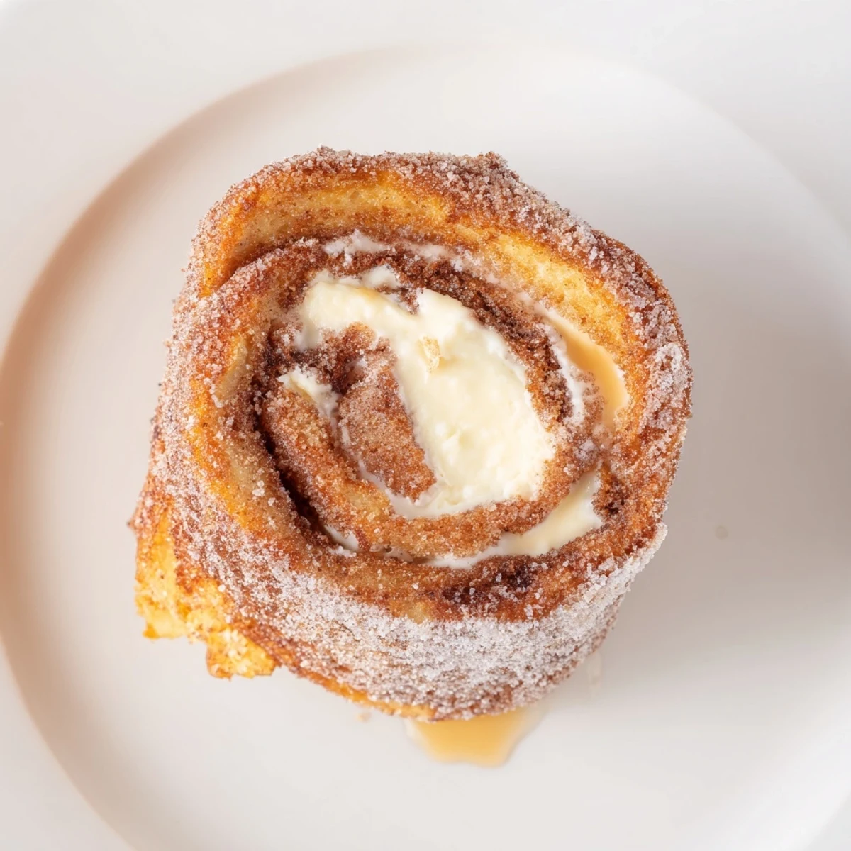 Stacked Cinnamon Roll French Toast Roll Ups with cream cheese filling, maple drizzle