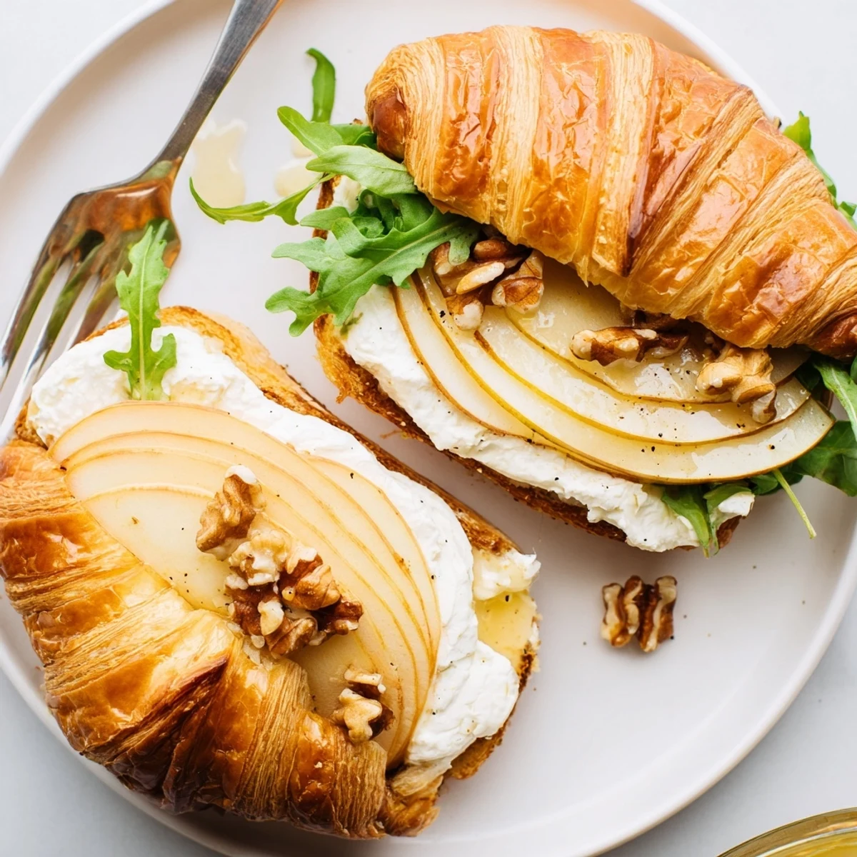 Apple Goat Cheese Croissant Sandwich, honey-drizzled, crisp apple and peppery arugula visible