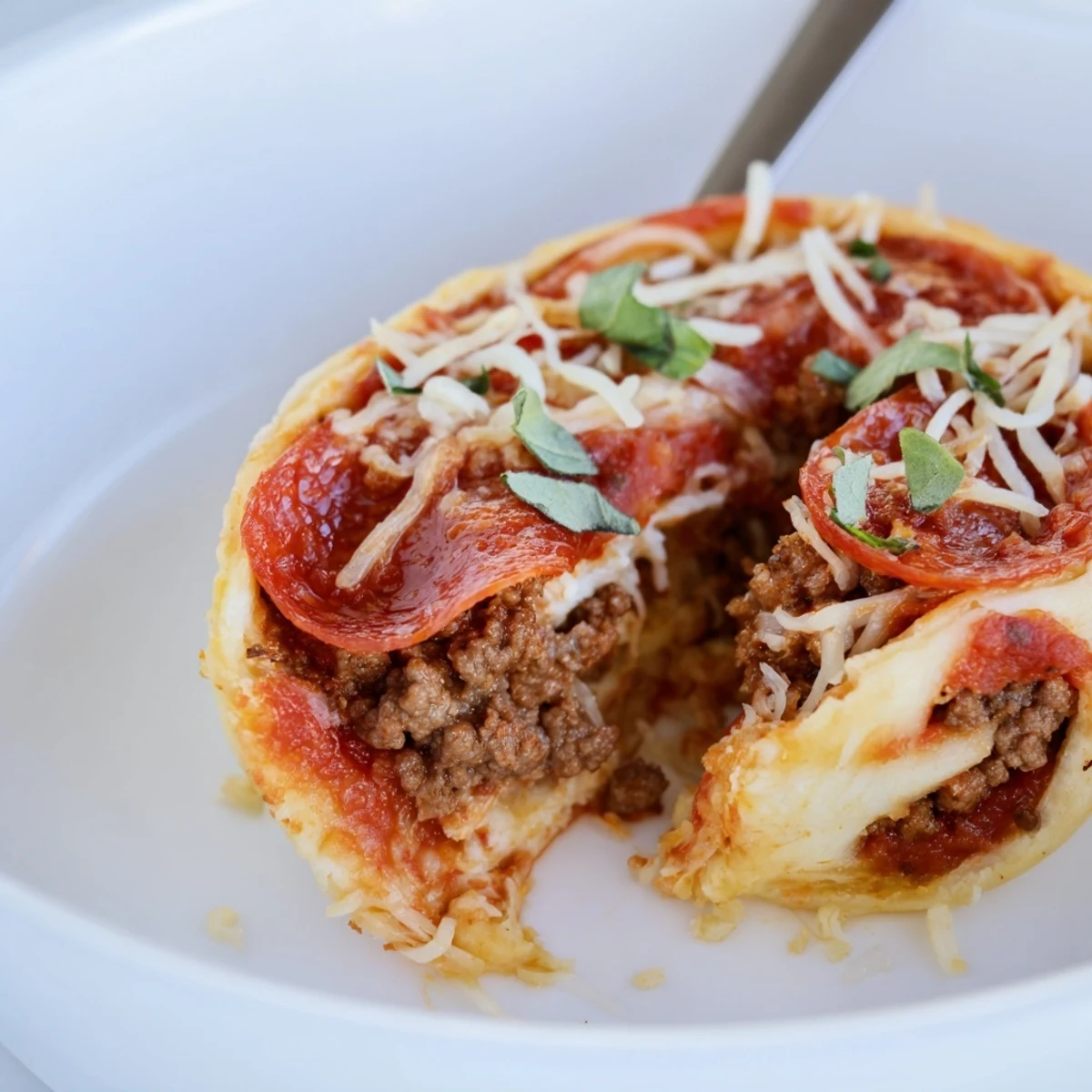 Warm Cheesy Beef Pepperoni Pizza Roll Ups Snack Recipe served with marinara dipping sauce.