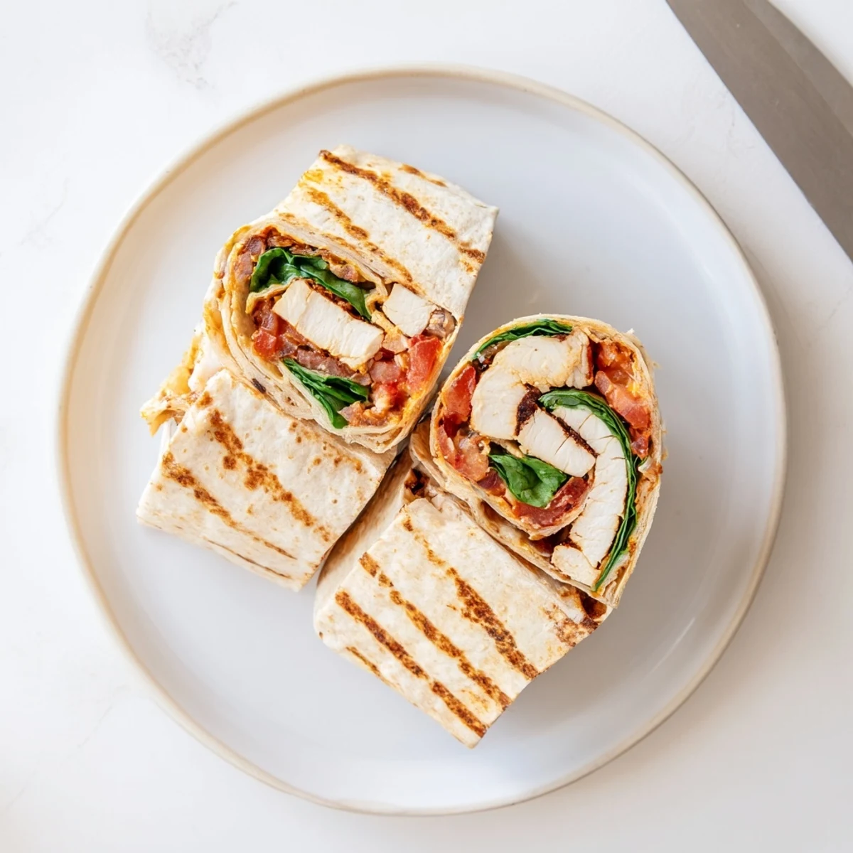 Grilled Cheesy Garlic Chicken Wraps on skillet, golden crisp edges and steam rising