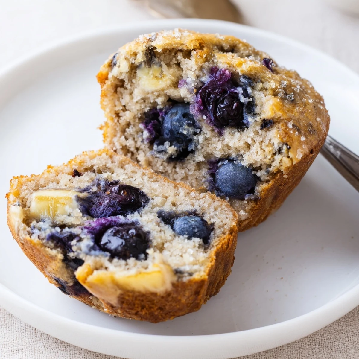 Blueberry Banana Muffins steaming on wire rack, bursting with juicy berries