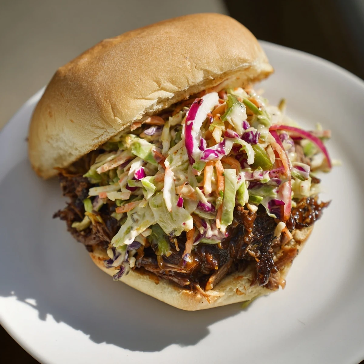 Hearty American sandwich featuring slow-cooked BBQ beef and fresh coleslaw on soft sandwich buns