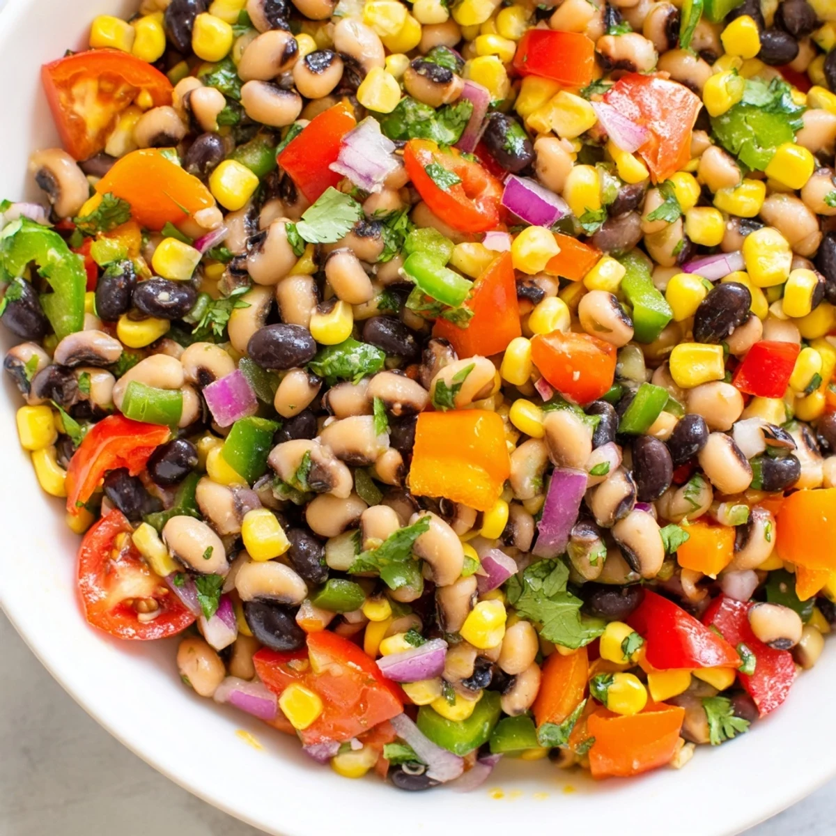 Colorful Cowboy Caviar in a rustic bowl studded with black beans and crisp peppers