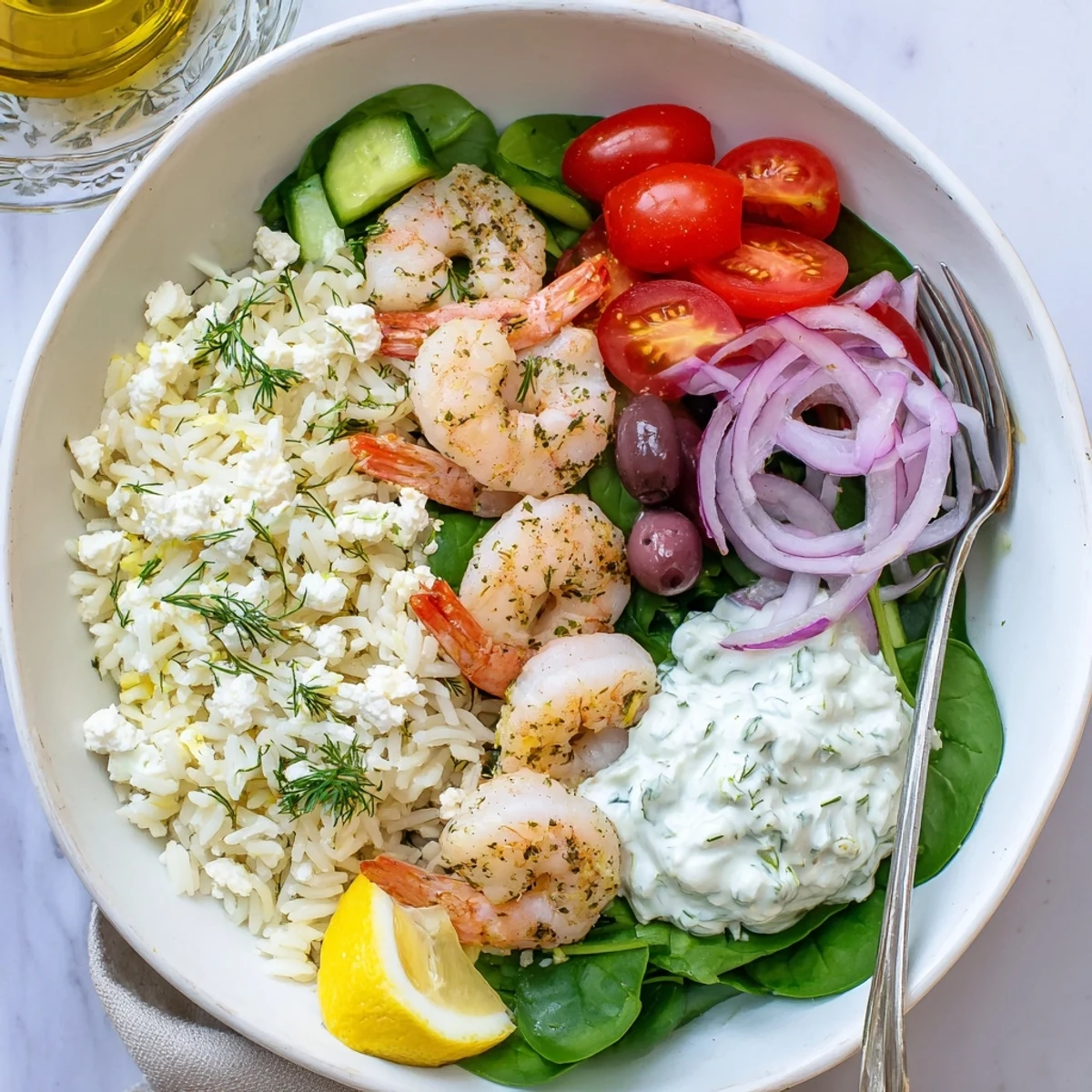 Golden seared shrimp atop a colorful Greek Shrimp Mediterranean Bowl with fresh vegetables