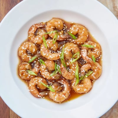 Sizzling High Protein Honey Garlic Shrimp in a glossy honey garlic sauce, served with steamed broccoli and a drizzle of sauce.