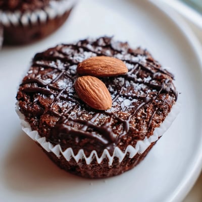 Decadent Flourless Almond Joy Cupcakes with gooey coconut centers on a rustic wire rack