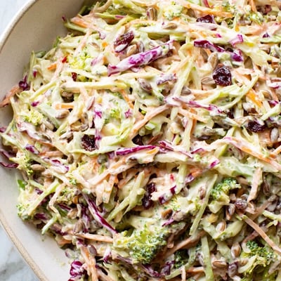 Crisp broccoli slaw tossed with red cabbage, scallions, and creamy mustard vinaigrette